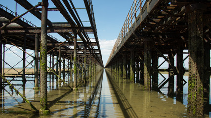 Under the Victorian pier at low tide looking to infinity