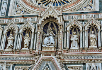 Fototapeta na wymiar Italian Renaissance. Duomo Florence Cathedral is the third largest church in the world. Architectural details of awesome marble facade with sculptures, painting, rosette. Italy, Florence