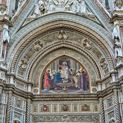 Fototapeta na wymiar Italian Renaissance. Amazing architectural details with painting, carving & decorations of awesome marble facade of Florence Cathedral. Medieval Art and Architecture. Italy, Florence