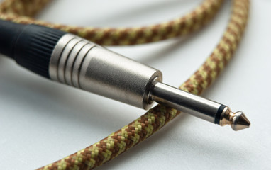 instrumental cable. guitar jack. close up shot.