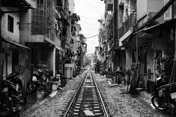 Hanoi Train Street. Vietnam city railway at rainy day. Famous tourist destination. Black and white filter