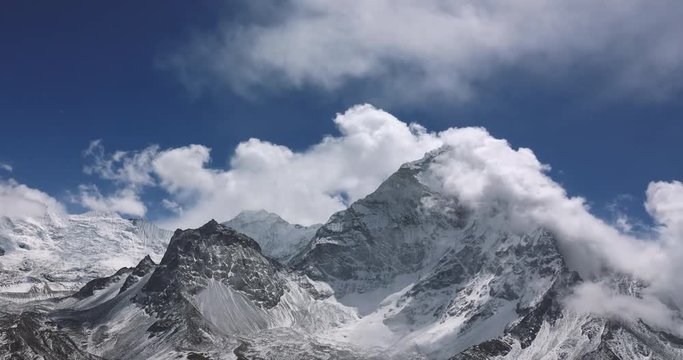 Snow Mountain Rock Peak with Moving clouds 4K Timelapse Video Nature Background abstract. Hiking Trekking Climbing Tourism to Everest in Nepal