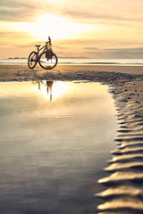 Fototapeta premium biking on punte malaka beach during sunset, koh tarutao
