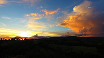 Aerial view of a sunset with sunbeams from forest. Countryside view. Fantastic landscape. Great colors and contrast