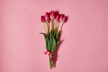 Bouquet of tulips on pink pastel background, copy space. Sping minimal concept. Womens Day, Mothers Day, Valentine's Day, Easter, birthday. Nature background. Flat lay, top view