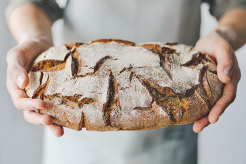 Baker or chef holding fresh made bread