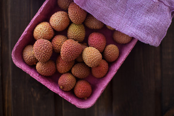 lychees litchi in a white plate on a wooden background