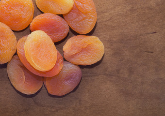Colored dried apricots on wooden table, closeup