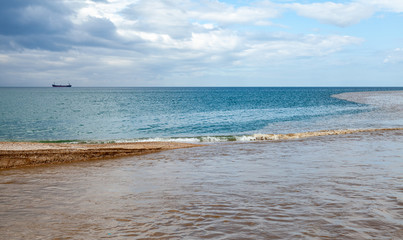 Summer seascape with muddy river water