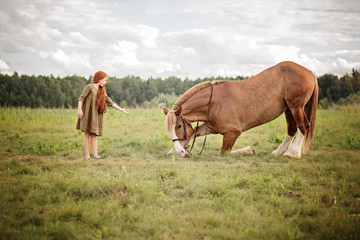 girl with horse in a field