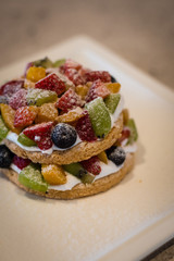 Almond dacquoise , fresh mousse cream, fresh mix fruit, toasted almonds