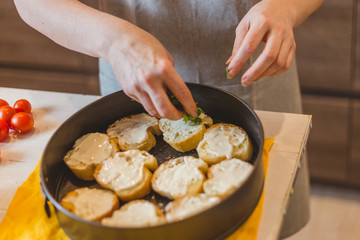 Closeup of housewife preparing snack - tapas and sandwiches - home cooking - step 14 put arugula and herbs on a baguette