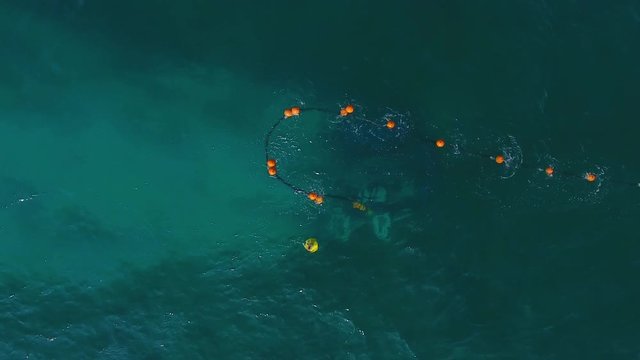 drone above the structure of an oil rig submarine cable station laying cables at the bottom of the sea