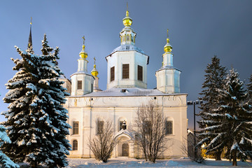 Cathedral of the Assumption (Uspensky Sobor) in the winter night, with snow covered firs. Veliky Ustyug, Vologda Region, Russia.