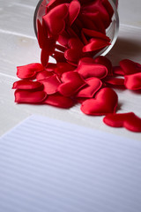 A lot of red symbols of love on the table. Love hearts.