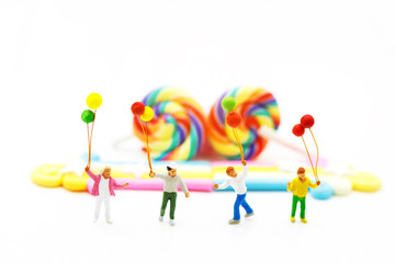 Miniature people: family and children enjoy with colorful balloons, happy family day concept.