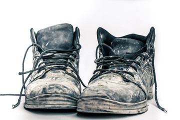old, dirty boots isolated on white background