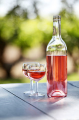 two glasses and a bottle of rose wine