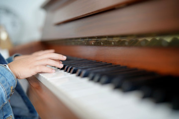 Child's hands playing the piano