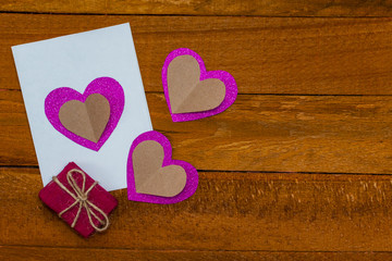 hand made postcard and a gift on a wooden background