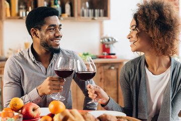 African-american couple enjoying romantic dinner at home