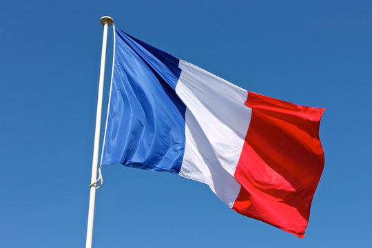 Flag of France waving over a blue sky