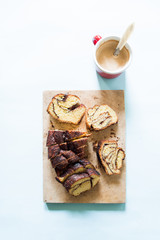 How to bake a babka jewish cake, series of images depictting how to make babka, based babka is ready to be eaten, over a blue background, easter concept.