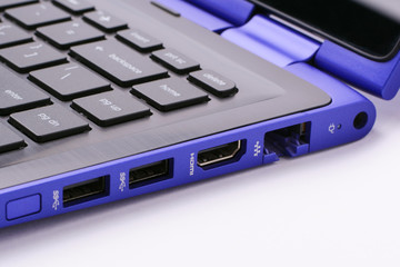 Modern Blue laptop with different ports on its side on a white background. USB, HDMI, LAN ports and power port on the side of the computer