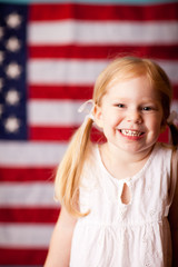 Happy Little Girl in Front of American Flag