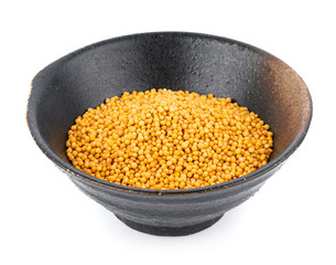 mustard seeds in bowl isolated on white background