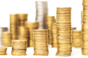 Close up photo of piles of golden coins showing upward direction with many coins at the background on a white background