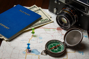 Compass with camera and passport on the map