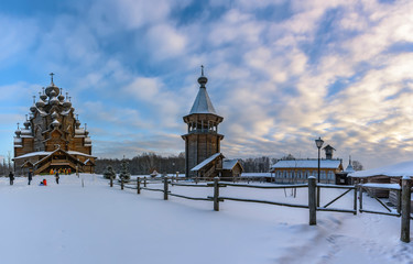 Winter day in the forest Park. Wooden Pokrovsky Cathedral, a monument of wooden architecture.