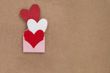 Valentine card. Handcrafted card expressing love. invitation card for wedding. Three hearts with envelope.