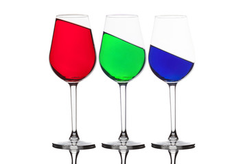 WIne glasses with different coloured drinks. Three different colored wine glasses isolated on white. Red, green and blue - RGB