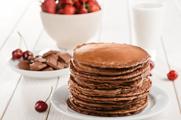 Pile of pancakes, chocolate, berries