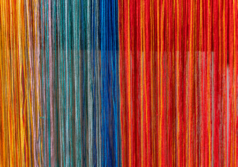 Colored threads of an ancient wooden loom
