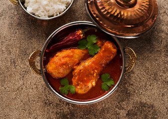 Indian dish chicken spicy curry masala. Spicy chicken legs with rice