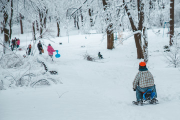 kid slighting from hill on sledge. winter time