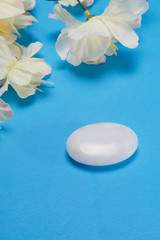 White flowers with a stone that depicts peace