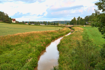 Small river between fields