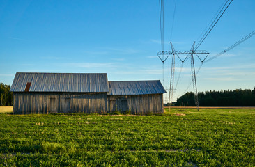 Fototapeta na wymiar Old storage barn and electricity wires