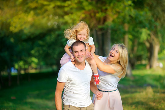 happy family in the evening park, walking and having fun