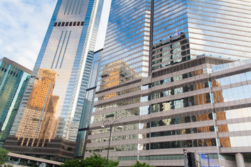 Modern office buildings in central Hong Kong. Modern architecture with windows reflecting sky and clouds.