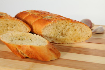 Garlic sliced baguette with oregano and basil