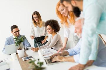 Joyful multiracial business team at work in modern office