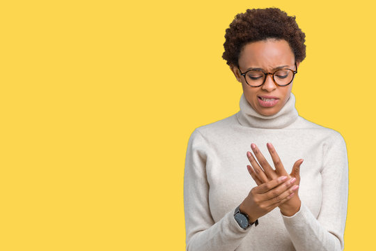 Young beautiful african american woman wearing glasses over isolated background Suffering pain on hands and fingers, arthritis inflammation