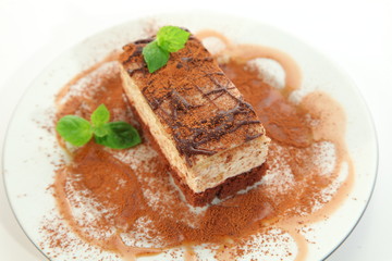 Piece of chocolate cheesecake decorated on the plate