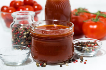 Products made with fresh tomato - sauce, juice and seasonings on white table, closeup