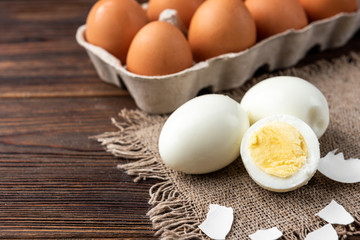 Boiled eggs on dark wooden background.